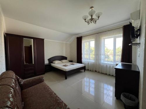 a living room with a couch and a bed at Admiral 2 in Koblevo