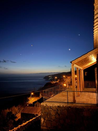 a building with a view of the ocean at night at Casa Oceano Pico in Lajes do Pico