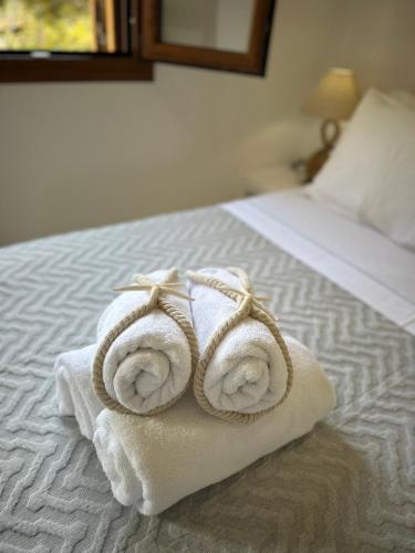 a pile of towels sitting on top of a bed at Divers House in Agrari
