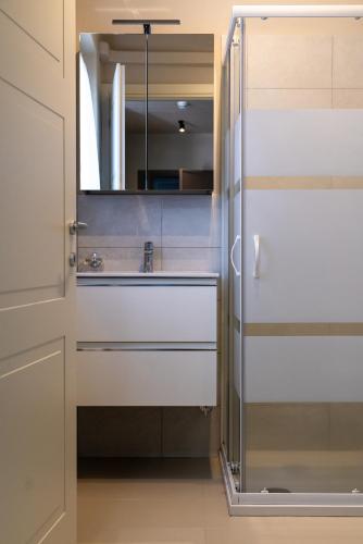 a bathroom with a sink and a mirror at Hotel Baia di Talamone in Talamone