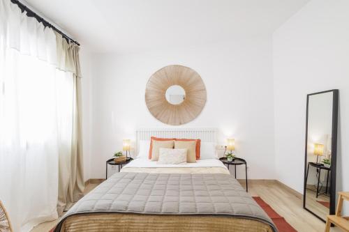 a bedroom with a large bed and a mirror at Apartament a Sant Celoni, Montseny, Barcelona in San Celoni
