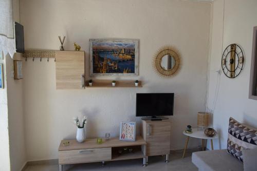 a living room with a couch and a tv at CapeVerde in Glóssa