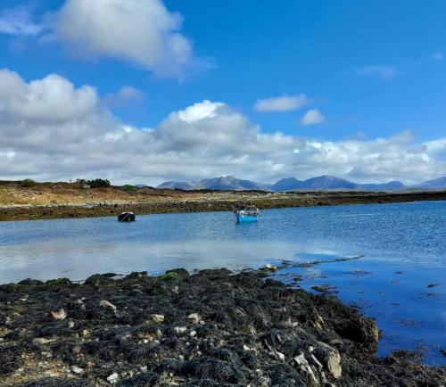 a small boat in a body of water at Inishnee Haven in Galway