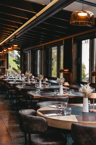 a row of tables and chairs in a restaurant at Le Saint Georges in Gruyères