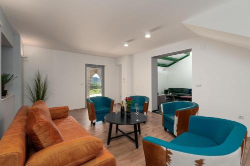 a living room with a couch and chairs and a table at Vila Agava, Konavle in Gruda