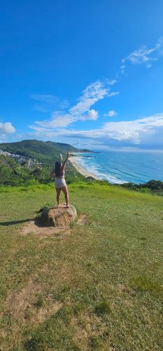 a person standing on top of a large rock at GH Bizkaia in Florianópolis