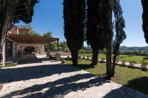 a path leading to a building with trees at Vila Agava, Konavle in Gruda