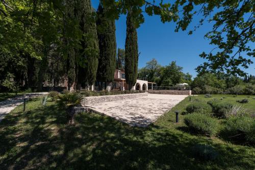 a garden with trees and a stone path at Vila Agava, Konavle in Gruda