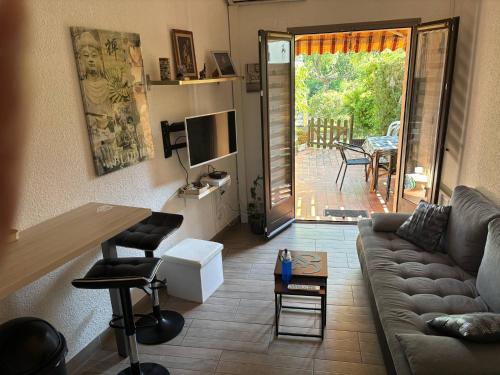 un salon avec un canapé et une table dans l'établissement Rez-de-jardin proche plage, à Cavalaire-sur-Mer