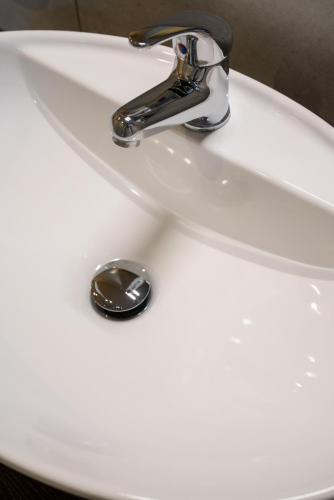 a bathroom sink with a chrome water faucet at Hotel Baia di Talamone in Talamone