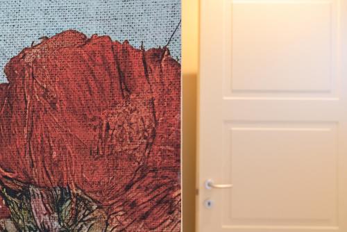 a door with a painting next to a wall at Hotel Baia di Talamone in Talamone
