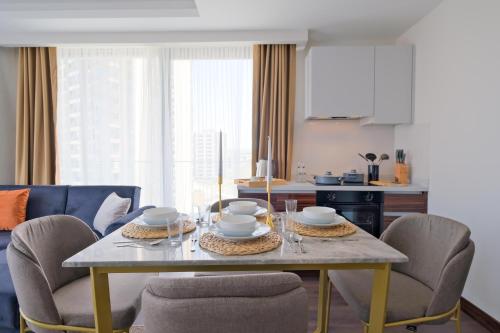 a dining room with a table and chairs at Modern Furnished Apartments in Istanbul Basaksehir By Iradah Gayrimenkul in Basaksehir