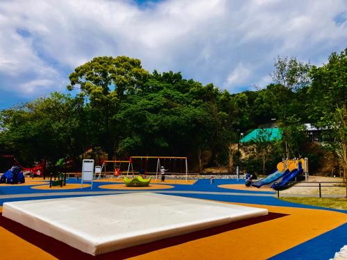a park with a playground with a slide at Airport Right Fukuoka in Fukuoka