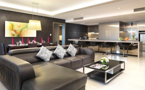 a living room with a couch and a table at St Giles Gardens Residences Kuala Lumpur in Kuala Lumpur