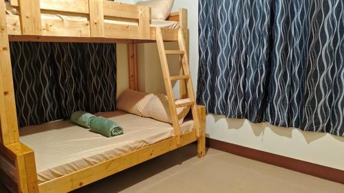a bunk bed with a ladder in a room at KBC ZAI Baguio Staycations 3 & 4 in Baguio