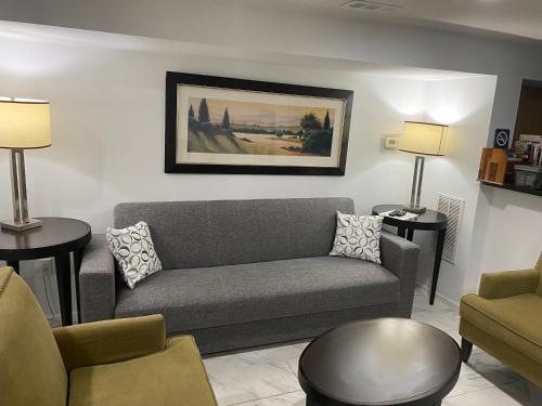a living room with a gray couch and two tables at Lovely Remodeled 2bdrm Basement Home in Washington