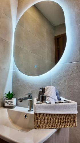 a bathroom with a sink with a mirror at Modern Studio close by La Carolina Metro station in Quito