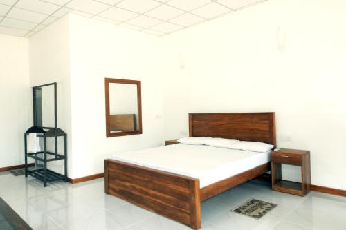 Postel nebo postele na pokoji v ubytování Coral Waves Inn Pasikuda