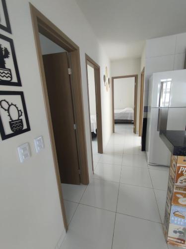 a room with a hallway with doors and a room with a television at Casa Sossego in Marechal Deodoro