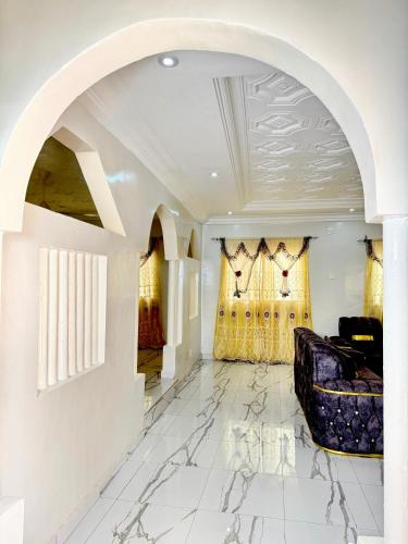 a living room with a couch and a ceiling at Paradise Holiday home in Busumbala