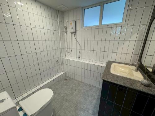 a white bathroom with a toilet and a sink at ChiangMai RedDoor Pool Villa in Chiang Mai