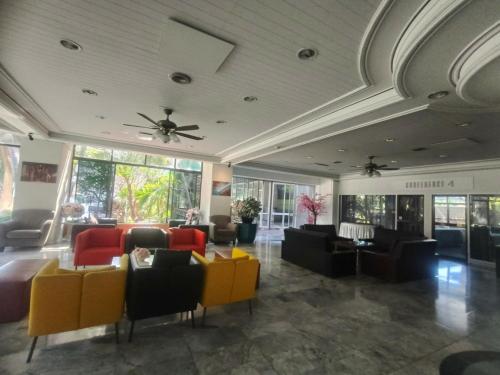 a lobby with couches and chairs and a ceiling at First Pacific Cirrus in Pattaya Central