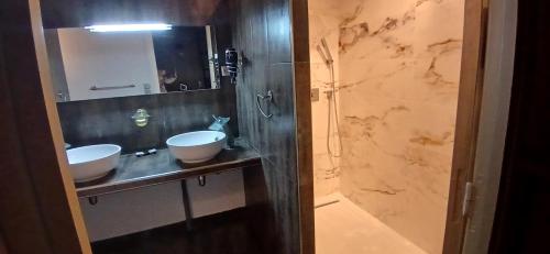 a bathroom with two sinks and a mirror at Occit'Homières in Saint-Pons