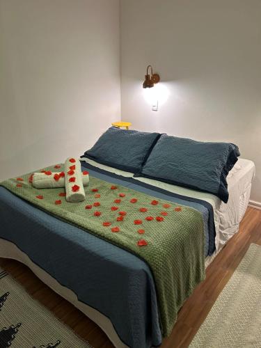 a bedroom with a bed with red roses on it at Canoa Abraão - Ilha Grande RJ in Abraão