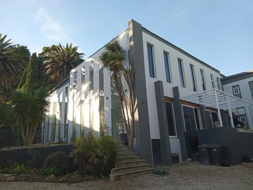 a building with palm trees in front of it at Retro Boutique in Cape Town