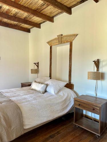 a bedroom with a bed and a wooden table at Casa Antigua Bed and Breakfast Chile in Casablanca