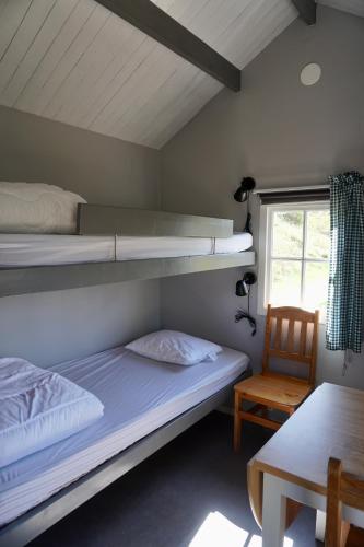 a room with two bunk beds and a table at Vimmerby Camping in Vimmerby