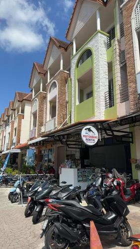a row of motorcycles parked in front of a building at Sea Boss Homestay in Kata Beach