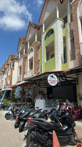 a row of motorcycles parked in front of a building at Sea Boss Homestay in Kata Beach