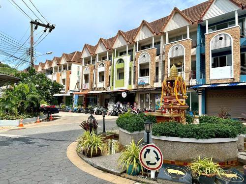 a street in a town with buildings and a street sign at Sea Boss Homestay in Kata Beach