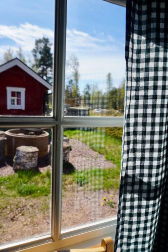a window with a view of a red barn at Vimmerby Camping in Vimmerby