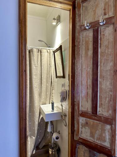 a bathroom with a sink and a mirror at Casa Antigua Bed and Breakfast Chile in Casablanca