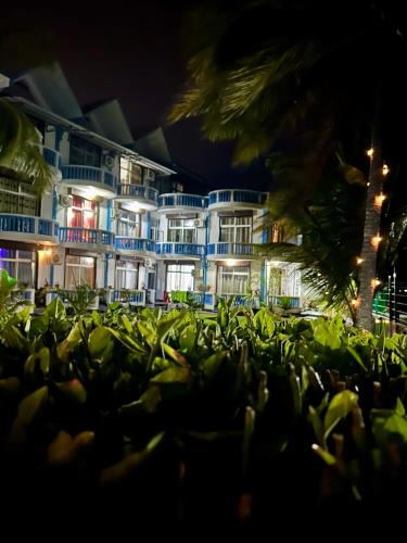a group of plants in front of a building at night at Coco Villa in Mahébourg