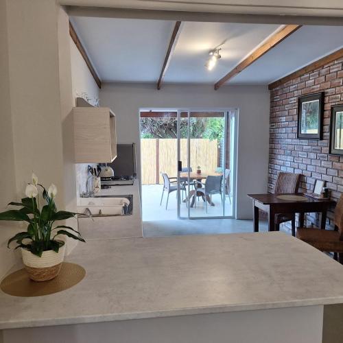 a kitchen and living room with a table and chairs at 177 on Church in Oudtshoorn