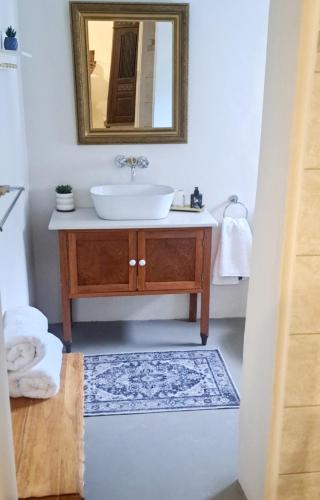 a bathroom with a sink and a mirror at 177 on Church in Oudtshoorn