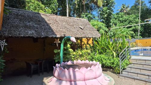 a house with a large pink cake in front of it at Swargam Pool Resort in Varkala