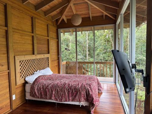 a bedroom with a bed and a large window at Accommodation in Cerro Punta in Cerro Punta