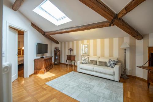 a living room with a couch and a television at Romantic and Charming Apartments in Florence
