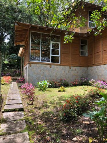 a house with a garden in front of it at Accommodation in Cerro Punta in Cerro Punta