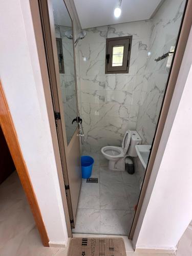 a bathroom with a shower and a toilet at Basma House , Peaceful Stay with Stunning Views in Ksar es Sghir
