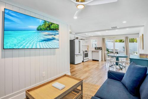 a living room with a tv hanging on a wall at Tropical Breeze Resort in Siesta Key