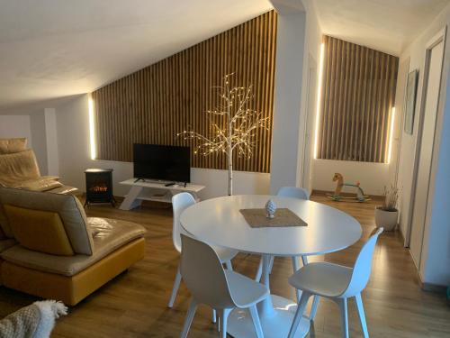 a living room with a table and chairs and a couch at Casa del sole in Nova Siri Marina