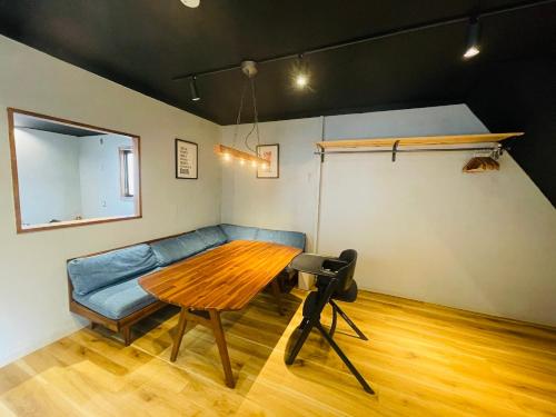 a living room with a couch and a wooden table at Airport Right Fukuoka in Fukuoka