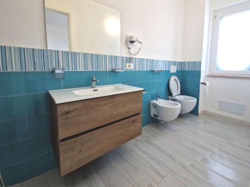a bathroom with a sink and a toilet at Perla Blu Tropea in Tropea
