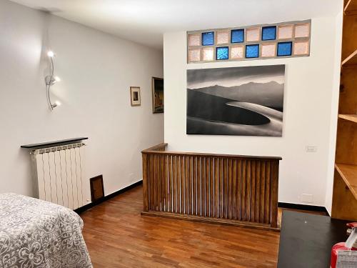 a bedroom with a bed and a painting on the wall at Casa Alba in Monterosso al Mare