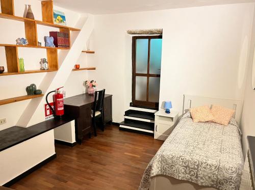 a bedroom with a bed and a desk and shelves at Casa Alba in Monterosso al Mare